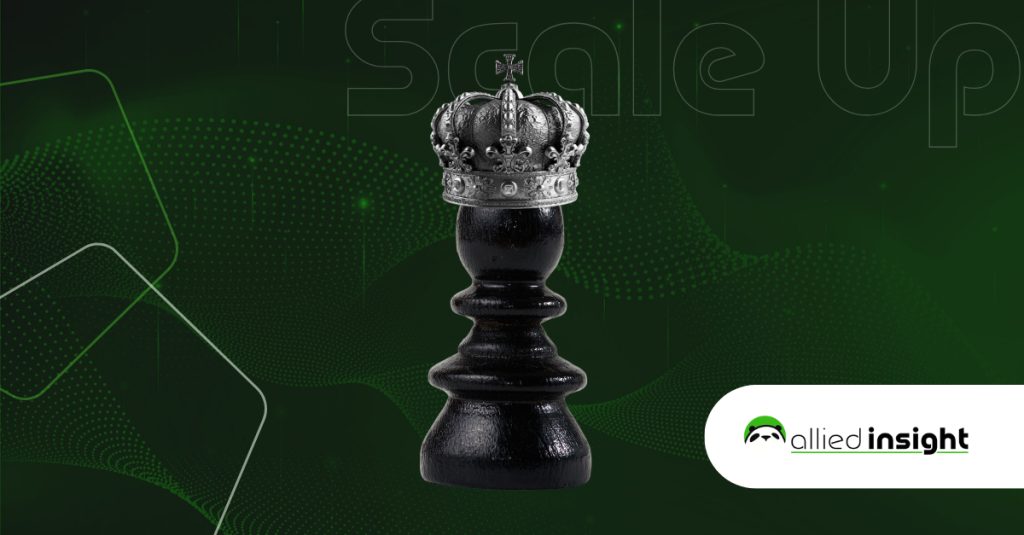 A black chess piece with a crown on top of it.